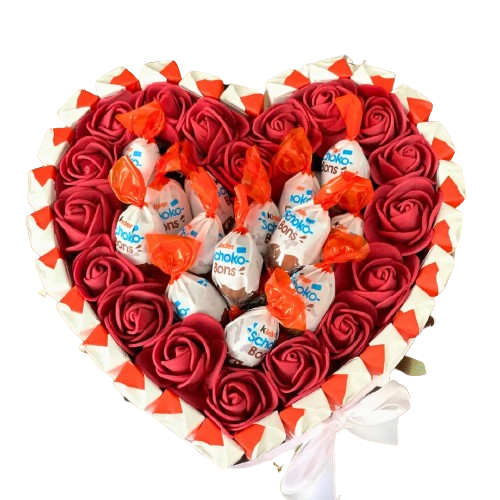 Grand arrangement floral en forme de cœur composé de roses rouges, avec des chocolats insérés